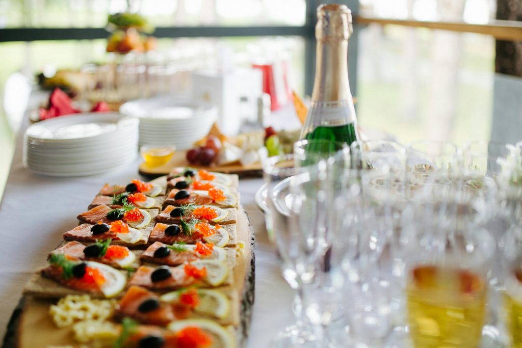 Platter of gourmet appetizers served with champagne for a stylish event.