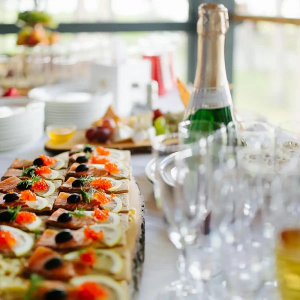 Platter of gourmet appetizers served with champagne for a stylish event.
